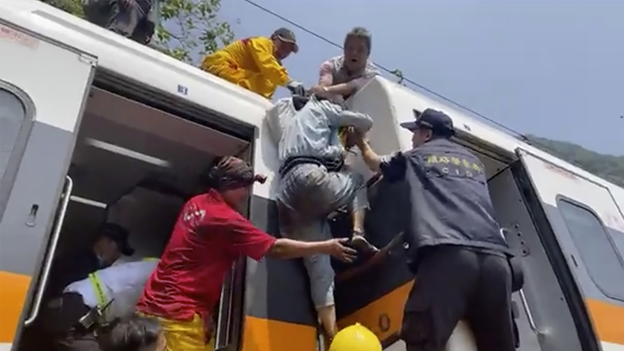 Photos: Train derails in Taiwan, killing at least 48 and injuring dozens
