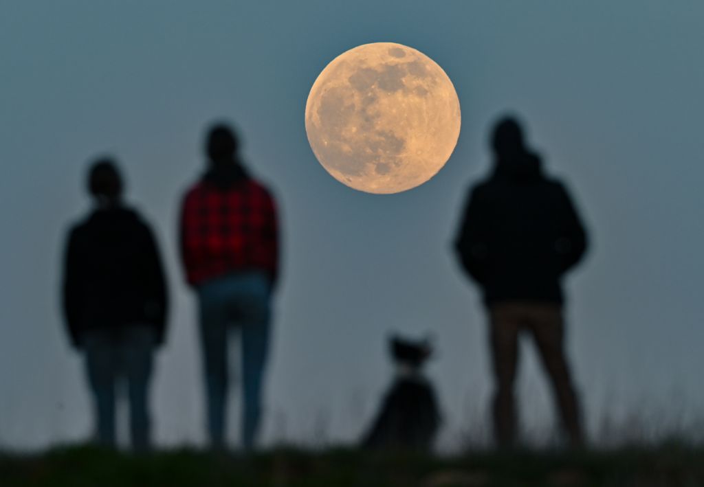 Photos: Super Pink Moon, April's full moon, brightens the night sky