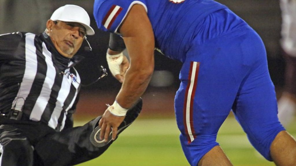 Texas football player bowls over referee