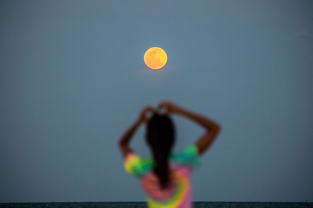 Photos: Super Pink Moon, April's full moon, brightens the night sky