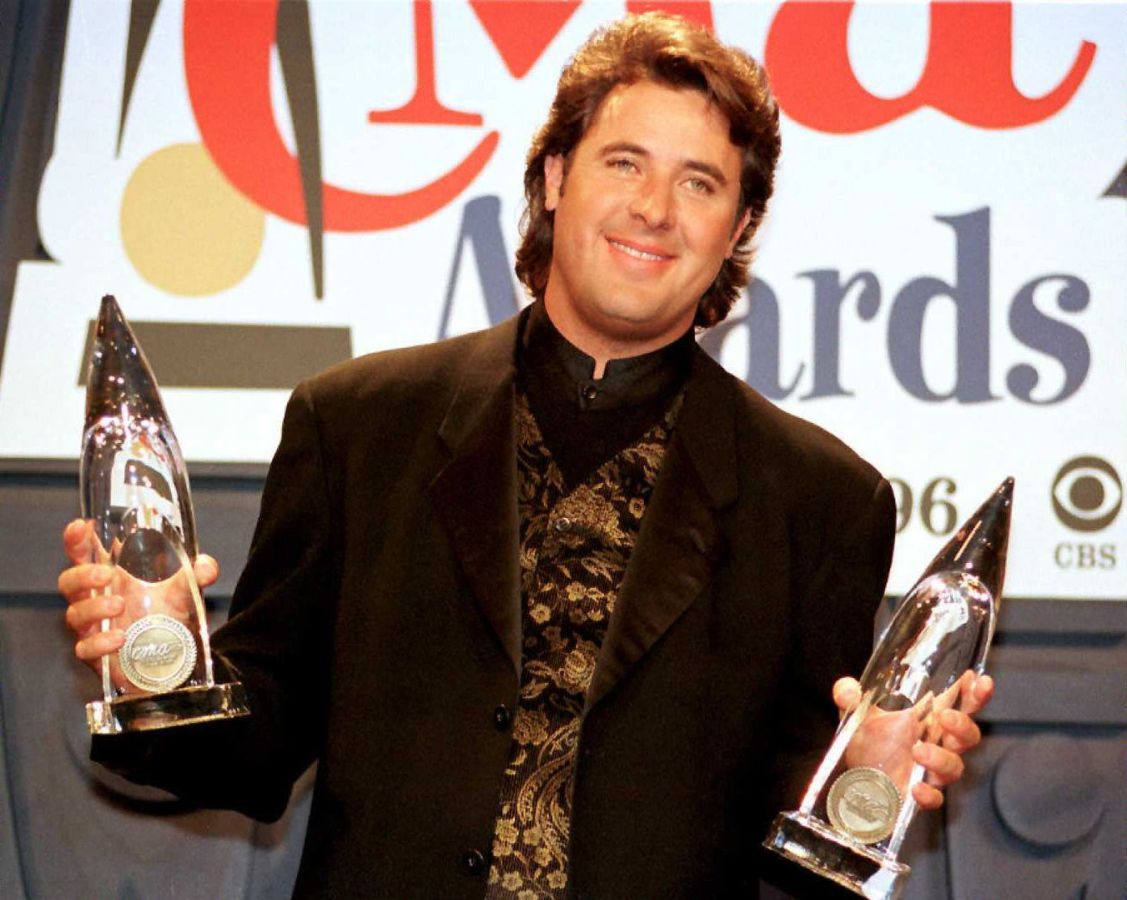 CMA Host Vince Gill stands with the two awards he