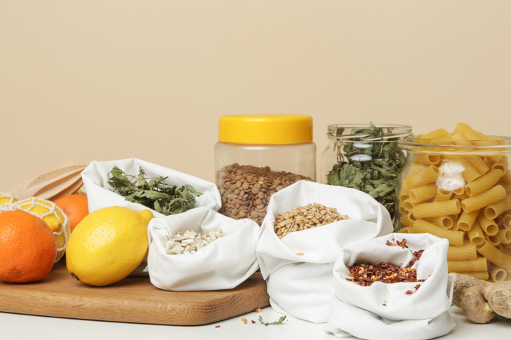 Food in bulk sacks. Zero waste and plastic free shopping concept. Sustainable lifestyle. Groceries in reusable textile bags on table.