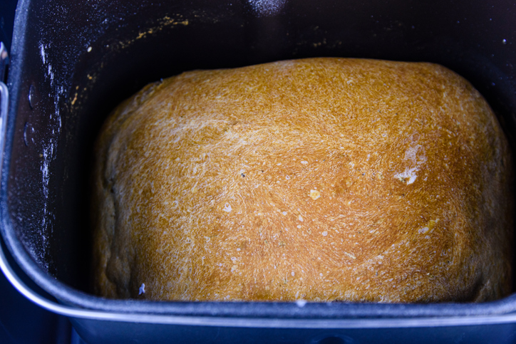 White loaf of bread preparing in automatic bread maker