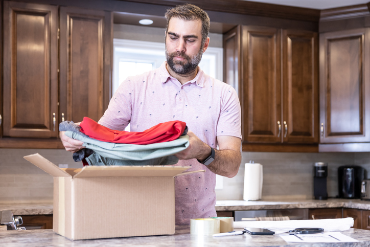 Man Returning Clothing in Package From Home