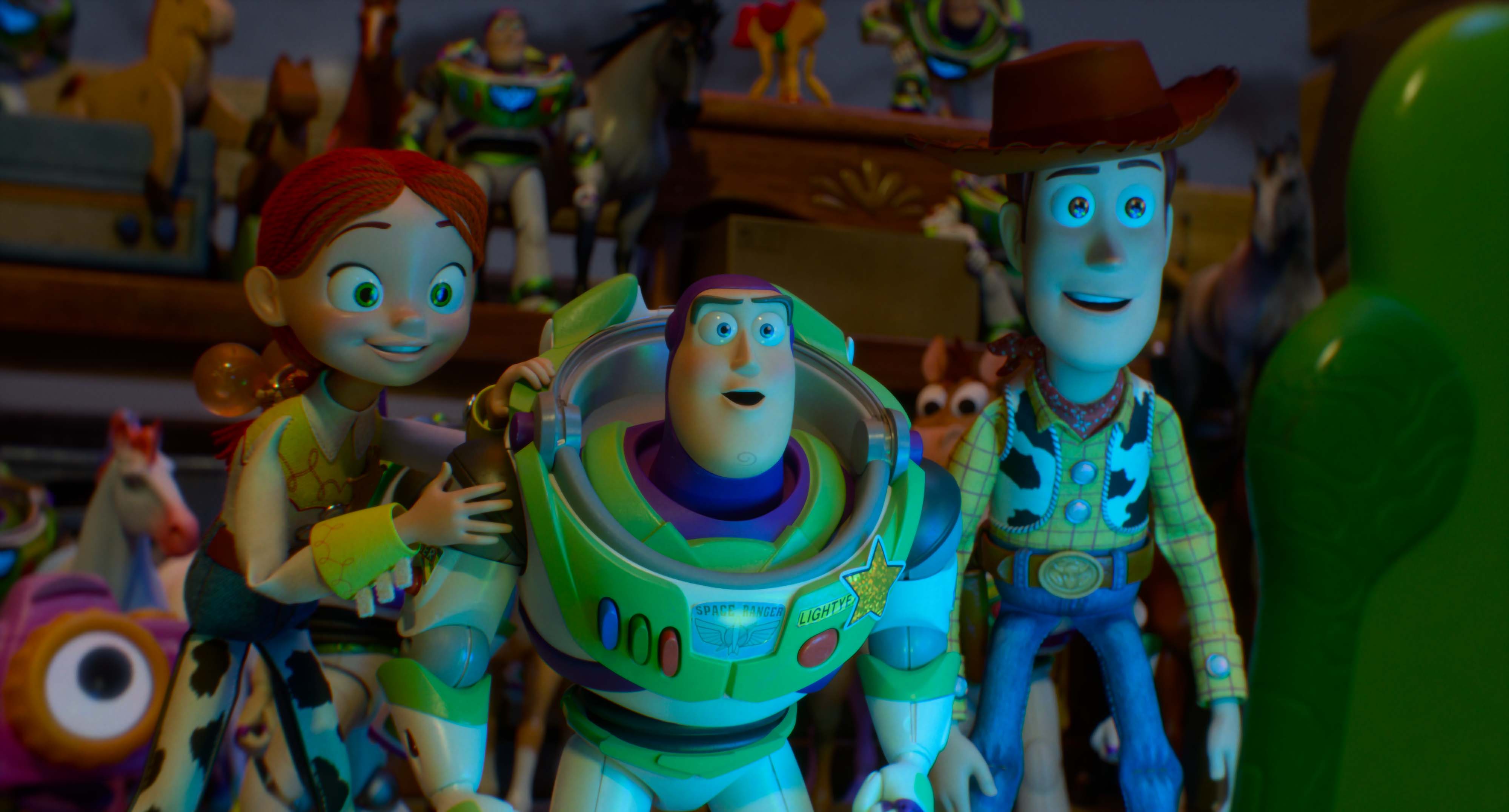 Jessie, Buzz Lightyear, and Woody, characters from the Toy Story franchise, standing together in a toy-filled room.