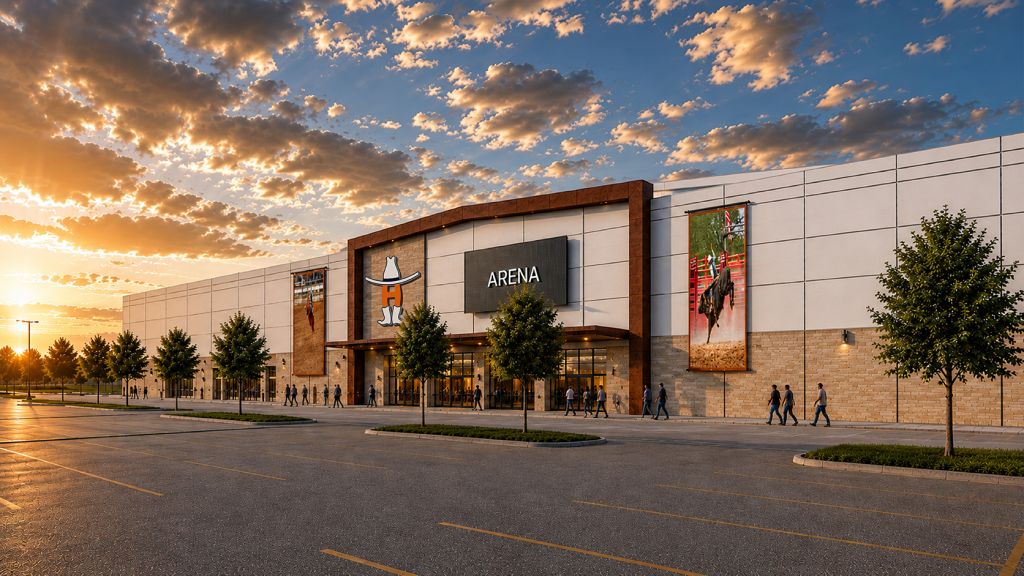 A large arena building with the "ARENA" logo displayed, surrounded by trees and a parking lot, set against a dramatic sunset sky with clouds.