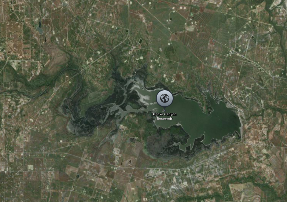 Aerial view of Choke Canyon Reservoir, a large body of water surrounded by rural countryside.