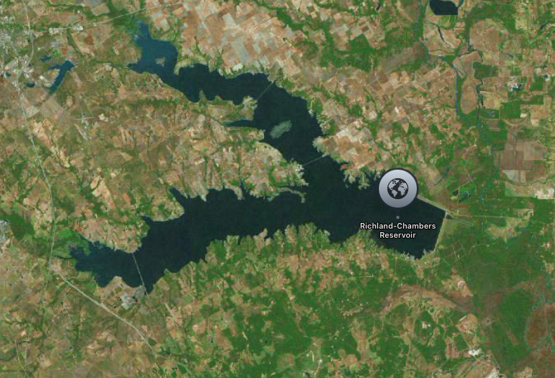 Satellite image of Richland-Chambers Reservoir, a large body of water surrounded by rural, forested land.