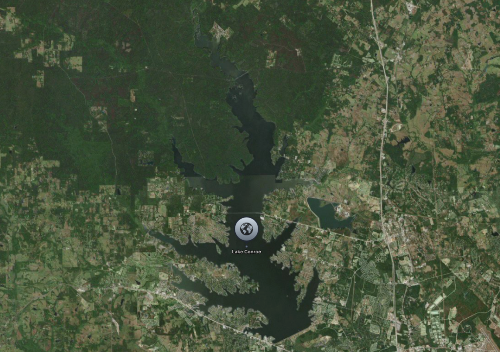 Aerial view of Lake Conroe, a large lake surrounded by forested areas.