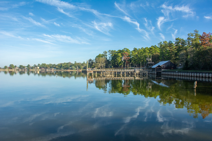 Serene view of Lake Livingston reservoir with nice coulds reflecting in still waters in the East Texas Piney Woods in Polk County, Texas, United States