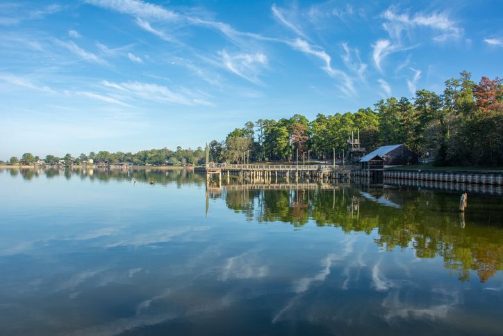 Serene view of Lake Livingston reservoir with nice coulds reflecting in still waters in the East Texas Piney Woods in Polk County, Texas, United States