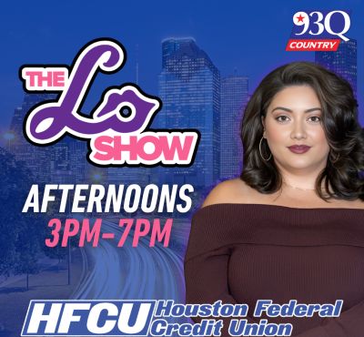 A woman with dark hair and makeup poses in front of a city skyline. The text on the image reads "The Lo Show Afternoons 3PM-7PM" and "HFCU Houston Federal Credit Union".